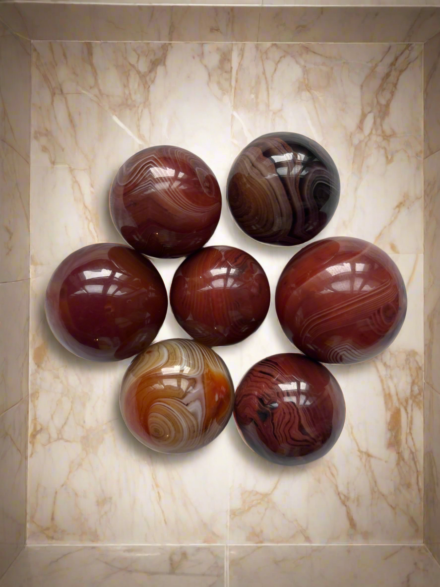 Sardonyx crystal sphere close-up showing natural banding and polished finish